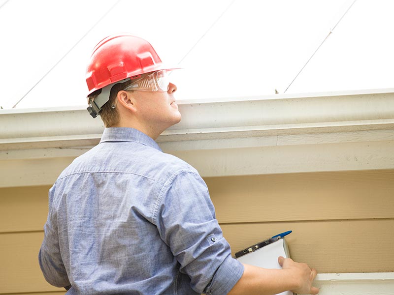 consultant inspecting gutter